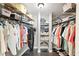 Walk in closet with metal shelving, ample clothing storage, and gray tile flooring at 9072 Baywood Park Dr, Seminole, FL 33777