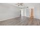 Bedroom featuring laminate flooring, neutral colors, ceiling fan, and ensuite bathroom at 942 Capri Isles Blvd # 207, Venice, FL 34292
