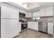 Updated kitchen features stainless steel appliances, white cabinets, and granite countertops at 942 Capri Isles Blvd # 207, Venice, FL 34292