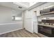 Kitchen featuring modern appliances, white cabinets and hardware, and a skylight at 942 Capri Isles Blvd # 207, Venice, FL 34292