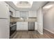Bright kitchen with stainless steel appliances, white cabinets, and skylight at 942 Capri Isles Blvd # 207, Venice, FL 34292