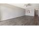 Open living area with hardwood flooring, ceiling fan, open floor plan and kitchen pass-through at 942 Capri Isles Blvd # 207, Venice, FL 34292