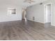 Spacious living room featuring hardwood flooring, ceiling fan, and an open floor plan at 942 Capri Isles Blvd # 207, Venice, FL 34292