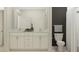 Bright bathroom with double vanity sink, granite countertops, and white cabinets at 9645 Runaway Breeze Dr, Land O Lakes, FL 34637