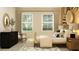 Inviting bedroom featuring large windows, a stylish rattan bed, and modern decor at 9645 Runaway Breeze Dr, Land O Lakes, FL 34637