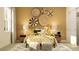 Bright bedroom with decorative wall art, a rattan bed frame, and matching nightstands at 9645 Runaway Breeze Dr, Land O Lakes, FL 34637