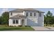 New construction two-story home featuring an attached three car garage and manicured lawn at 9645 Runaway Breeze Dr, Land O Lakes, FL 34637