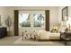 Bright primary bedroom with seating, large windows, neutral decor, and modern furniture at 9645 Runaway Breeze Dr, Land O Lakes, FL 34637