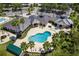 Overhead view of the clubhouse showcasing a pool, seating areas, and lush tropical landscaping at 10141 Deercliff Dr, Tampa, FL 33647