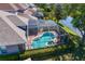 Drone view of screened-in pool and patio on waterfront with lush landscaping and backyard at 10141 Deercliff Dr, Tampa, FL 33647