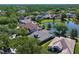 Aerial shot showcasing homes with pools and lake views within a lush, green community at 10141 Deercliff Dr, Tampa, FL 33647