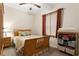 A modest bedroom with a double bed, dresser, storage and window in a neutral color scheme at 10141 Deercliff Dr, Tampa, FL 33647