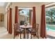 Charming breakfast nook features a dining table and a lovely view of the backyard patio and pool at 10141 Deercliff Dr, Tampa, FL 33647
