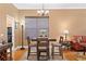 Well-lit dining area featuring hardwood floors, a ceiling fan, and views into living spaces at 10141 Deercliff Dr, Tampa, FL 33647