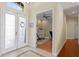 Welcoming foyer with tiled floors, a glass-paneled door, and an adjacent office space at 10141 Deercliff Dr, Tampa, FL 33647