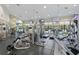 Spacious gym with lots of equipment, mirrors, ceiling fans, and wall mounted TV's at 10141 Deercliff Dr, Tampa, FL 33647