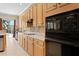 Bright kitchen showing an oven, counter space, wooden cabinets, tile backsplash and a view to the backyard pool at 10141 Deercliff Dr, Tampa, FL 33647