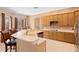 Bright kitchen with an island, bar seating, stainless steel appliances, and a view to the backyard at 10141 Deercliff Dr, Tampa, FL 33647