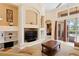 Bright living room with an entertainment center and access to outdoor patio with pool views at 10141 Deercliff Dr, Tampa, FL 33647