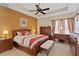 Elegant main bedroom boasts a ceiling fan, an ornate bed frame and decorative furniture at 10141 Deercliff Dr, Tampa, FL 33647