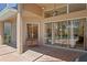 Covered brick patio with a seating swing and views of the pool and backyard through sliding glass doors at 10141 Deercliff Dr, Tampa, FL 33647