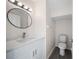 Bathroom featuring modern vanity, new fixture, toilet, and wood look flooring at 10503 Dotham Ct, Tampa, FL 33626