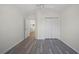 Spacious bedroom featuring gray wood-look flooring, a closet, and open doorway to the hall at 10503 Dotham Ct, Tampa, FL 33626