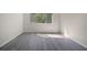 Well-lit bedroom showcasing a large window offering natural light and gray wood-look flooring at 10503 Dotham Ct, Tampa, FL 33626