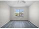 Bright bedroom with large window overlooking the neighborhood and featuring gray wood-look floors at 10503 Dotham Ct, Tampa, FL 33626