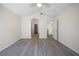 Bright bedroom featuring vaulted ceiling, ceiling fan, neutral walls, and gray wood-look flooring at 10503 Dotham Ct, Tampa, FL 33626