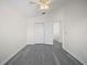 Bright bedroom features a closet and a doorway to the hall, complete with gray wood-look flooring at 10503 Dotham Ct, Tampa, FL 33626