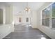 Bright dining room featuring modern light fixture, large window, and new flooring at 10503 Dotham Ct, Tampa, FL 33626