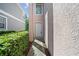 Well-lit front door with adjacent manicured hedges at 10503 Dotham Ct, Tampa, FL 33626