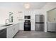 Bright kitchen featuring new stainless appliances, white cabinets and sink at 10503 Dotham Ct, Tampa, FL 33626