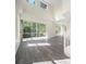 Bright living room with hardwood floors, large windows, and lots of natural light at 10503 Dotham Ct, Tampa, FL 33626