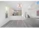 Bright living room featuring modern light fixture, an open floor plan, and new flooring at 10503 Dotham Ct, Tampa, FL 33626