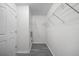 Bright walk-in closet with wire shelving and gray wood-look flooring at 10503 Dotham Ct, Tampa, FL 33626