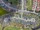 Stunning aerial view of a residential neighborhood featuring homes, golf course, and scenic waterways at 1112 Jasmine Creek Ct, Sun City Center, FL 33573