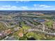 Beautiful aerial view showcasing the community's layout with lakes, green spaces, and residential areas at 1112 Jasmine Creek Ct, Sun City Center, FL 33573