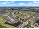 Breathtaking aerial view showcases a community featuring homes, golf courses, lakes and natural landscape at 1112 Jasmine Creek Ct, Sun City Center, FL 33573
