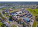 Aerial view of community recreation center featuring a pool, parking, shuffleboard, and green spaces at 1112 Jasmine Creek Ct, Sun City Center, FL 33573