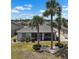 Aerial view of a single-story home with a screened lanai, manicured lawn, and decorative landscaping at 1112 Jasmine Creek Ct, Sun City Center, FL 33573