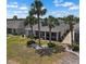 Aerial view of a home's backyard with well-kept lawn, a screened-in patio, and decorative landscaping at 1112 Jasmine Creek Ct, Sun City Center, FL 33573