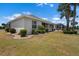 Landscaped backyard with well-kept lawn and a screened lanai; great outdoor space at 1112 Jasmine Creek Ct, Sun City Center, FL 33573