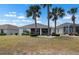 Backyard showcases lush lawn, manicured shrubbery, and an inviting screened lanai at 1112 Jasmine Creek Ct, Sun City Center, FL 33573