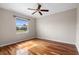 Bedroom with wood floors and ceiling fan with natural light from the windows at 1112 Jasmine Creek Ct, Sun City Center, FL 33573