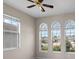 Bedroom with large windows, a ceiling fan, neutral walls, and base trim at 1112 Jasmine Creek Ct, Sun City Center, FL 33573