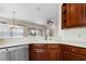 Kitchen features stainless steel dishwasher, white countertops, and dark wood cabinets at 1112 Jasmine Creek Ct, Sun City Center, FL 33573