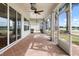 A screened lanai overlooks a serene lake with palm trees and landscaped gardens at 1112 Jasmine Creek Ct, Sun City Center, FL 33573
