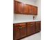Laundry room features white countertops and dark wood cabinets at 1112 Jasmine Creek Ct, Sun City Center, FL 33573